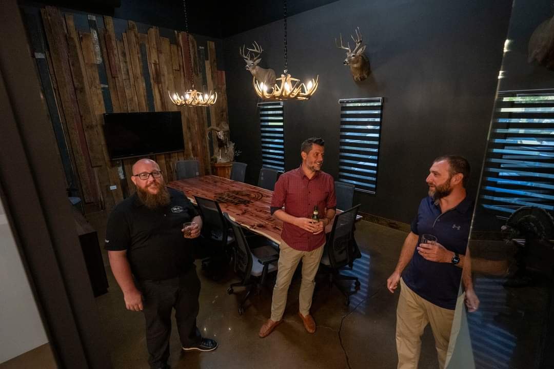 Guests gather around tables in a separate room at Adventure Unknown during its grand opening.