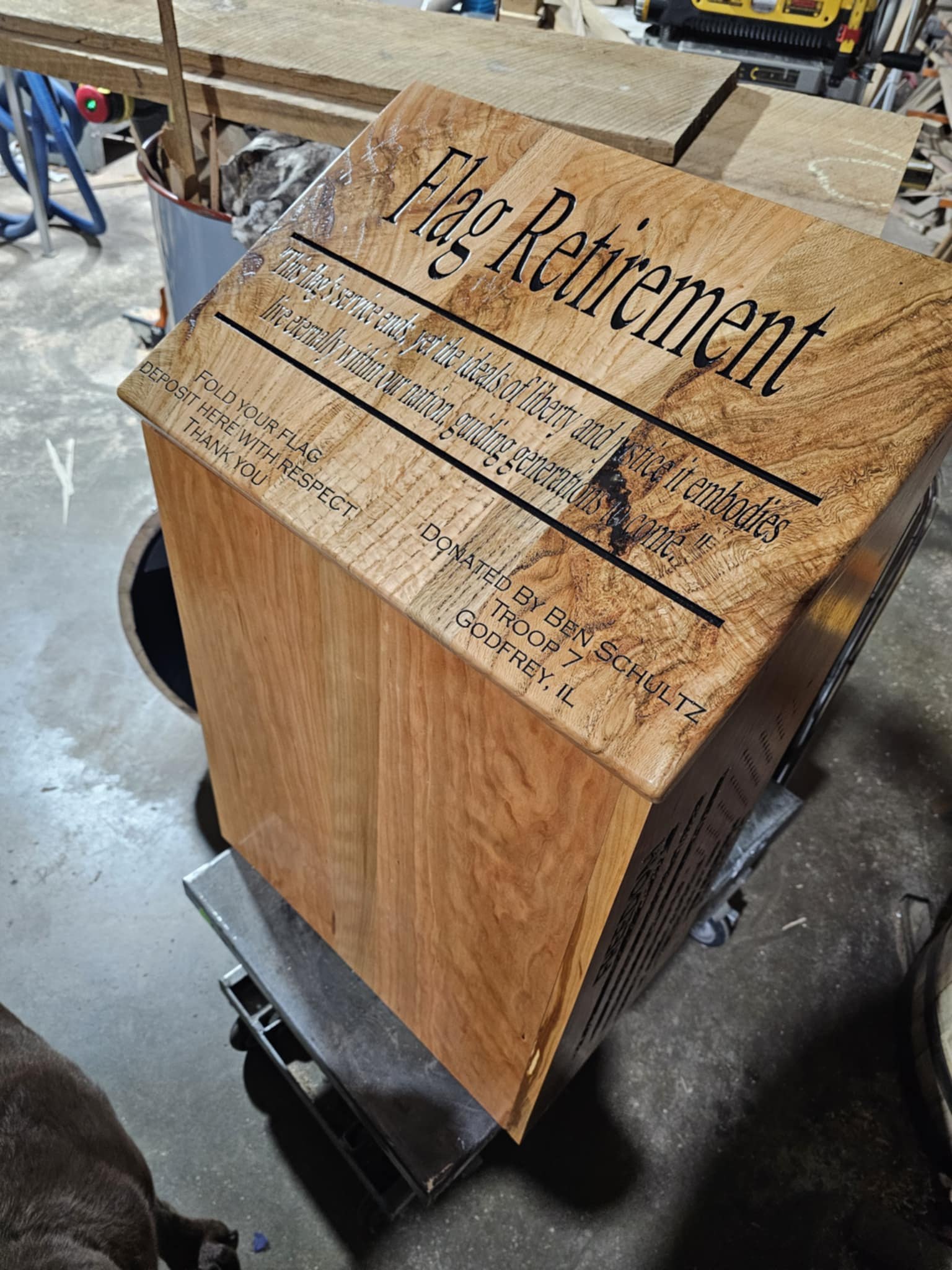 Wooden flag-retirement collection box with an engraved lid, deposit slot and dedication to Ben Schultz, Troop 7, Godfrey, Illinois.