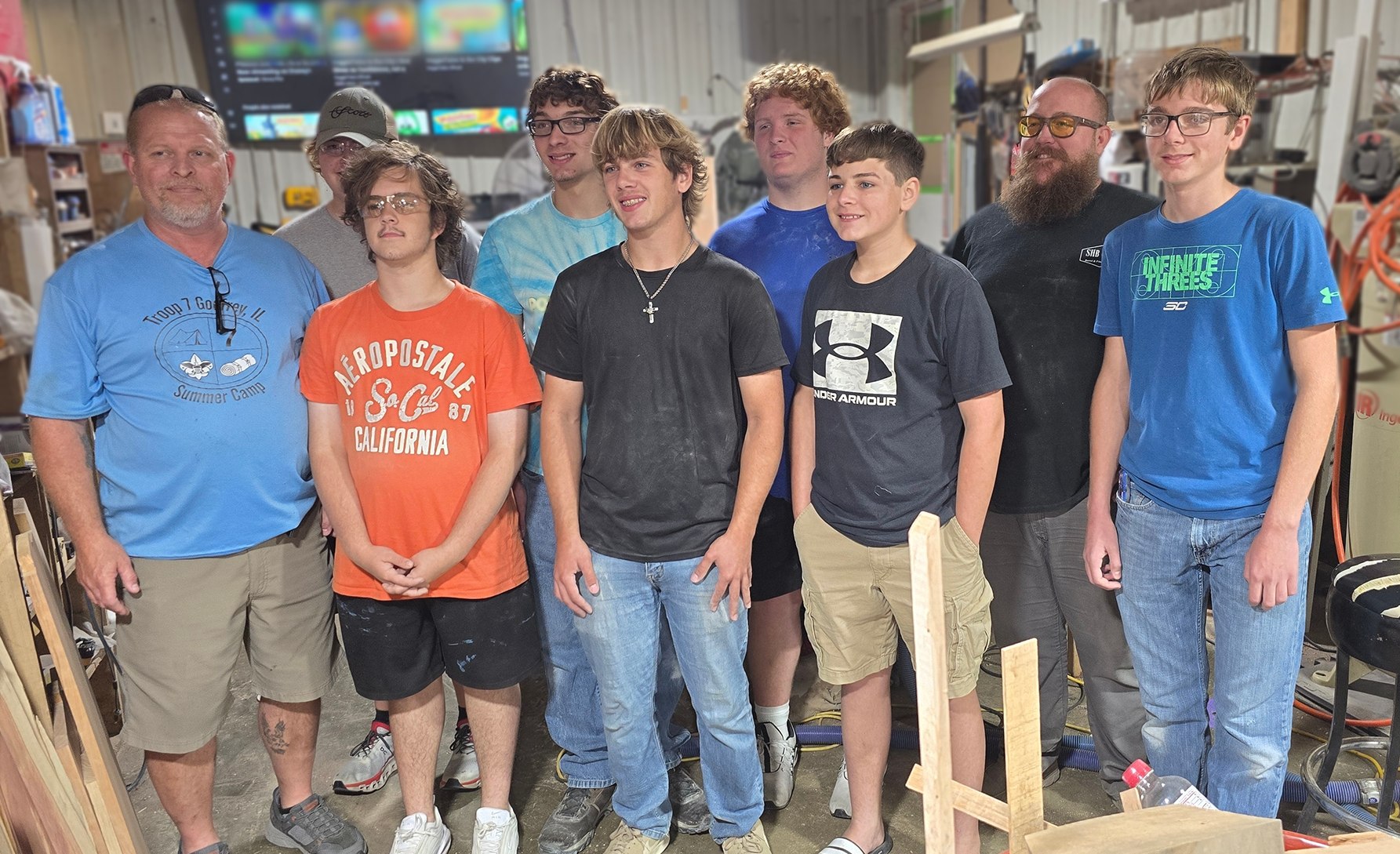 A small group gathered in the workshop during the flag-retirement box project.