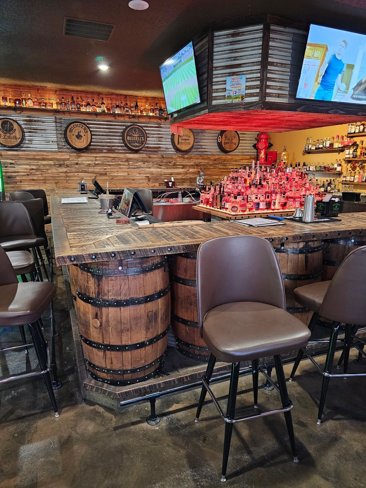 Finished Kentucky Burn bar with wood-stave surfaces and barrel-front details.
