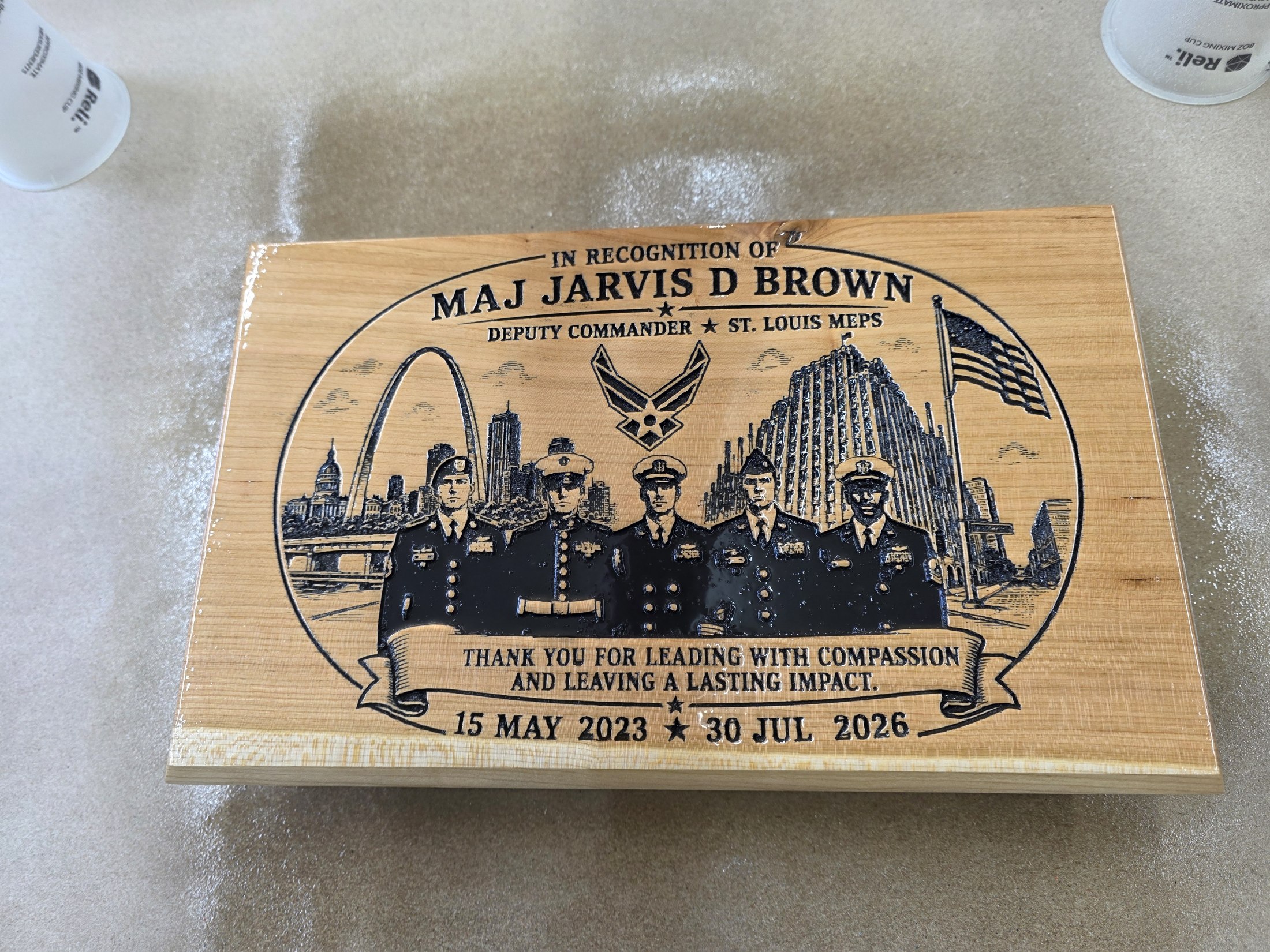 Engraved wooden recognition plaque for Major Jarvis D. Brown, showing service members and St. Louis landmarks.