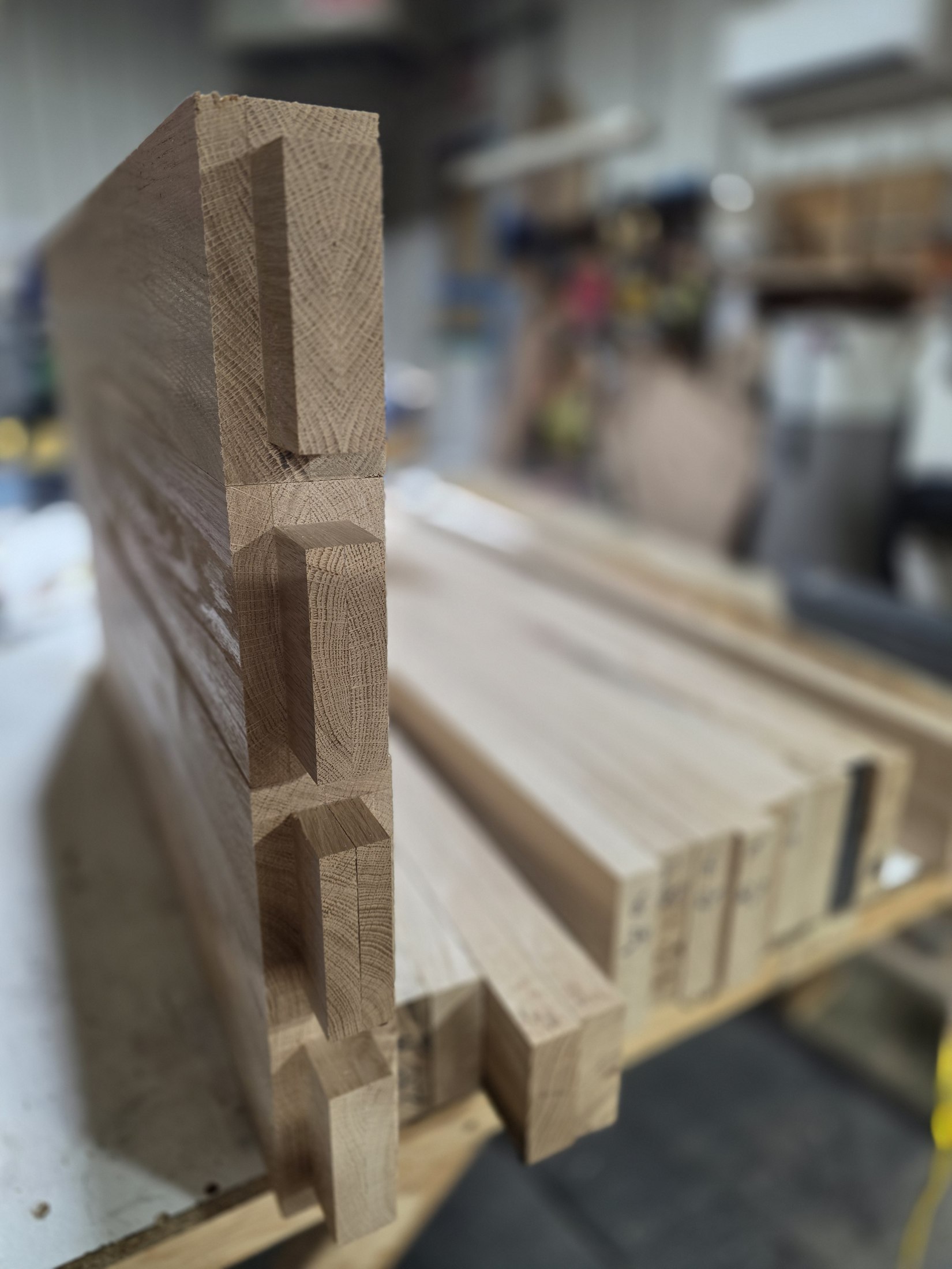 Close-up of rectangular tenons projecting from wooden frame members, with end grain visible.
