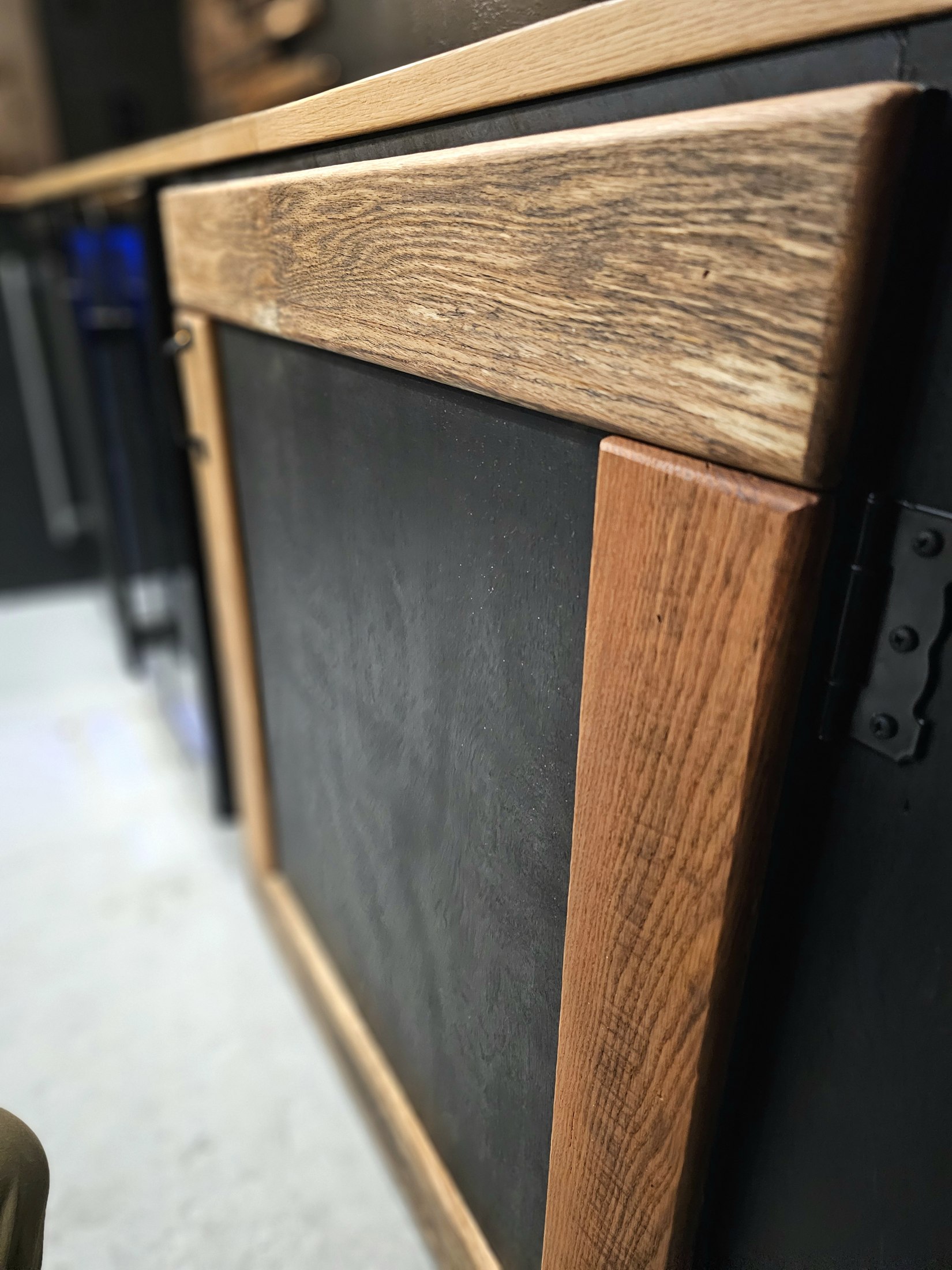 Wood-framed lower bar cabinetry with dark inset panels beneath the counter.